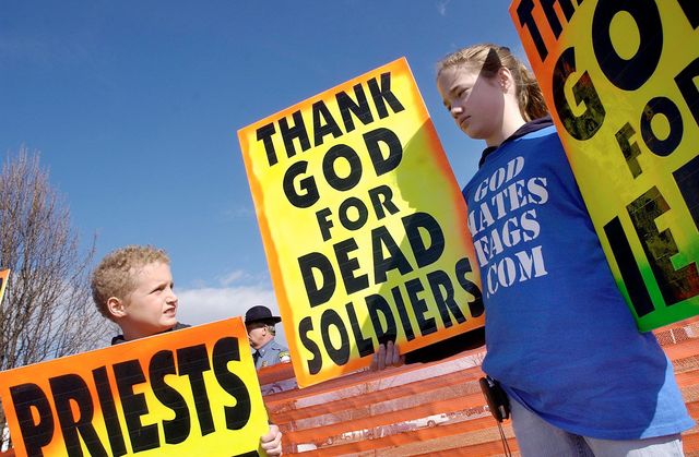 Westboro Baptist Church member Gabriel Phelps-Roper, 10, and sister Grace Phelps-Roper, 13, protest at the funeral of Marine Lance Cpl. Matthew A. Snyder in 2006. (Associated Press)